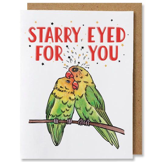 An illustrated greeting card featuring two yellow and green lovebirds in an embrace, sitting on a branch with stars in their eyes. The caption reads "Starry eyed for you"