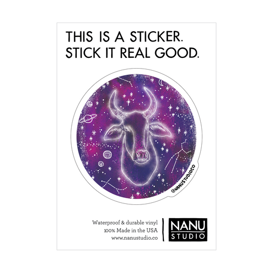 An illustrated sticker featuring a dark blue starlit background with an image of a cow with large horns in the centre which seems as though it's glowing, accompanied by three constellations: Taurus, Aries and Gemini