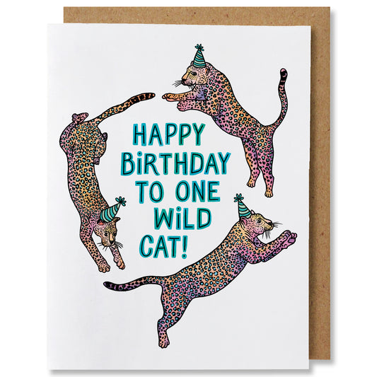 An illustrated greeting card featuring three wild cats lunging in a circle wearing party hats. In the centre is the caption "happy birthday to one wild one"
