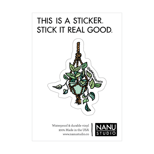 An illustrated sticker featuring a vine plant in a green planter hanging from a macrame rope hanger