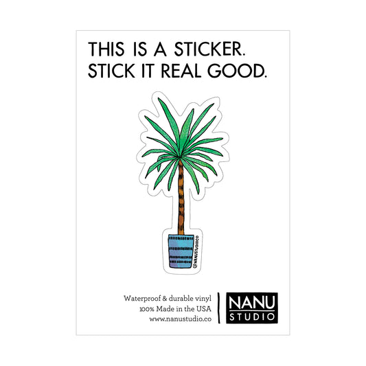 An illustrated sticker featuring a palm tree plant in a blue pot with a line pattern