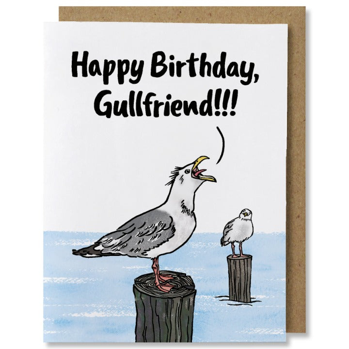 Illustrated birthday card featuring two seagulls standing on wood pylons in light blue water. the gull in foreground is yelling "happy birthday, gullfriend!!!" while the gull in background is starting questionably at the one yelling.