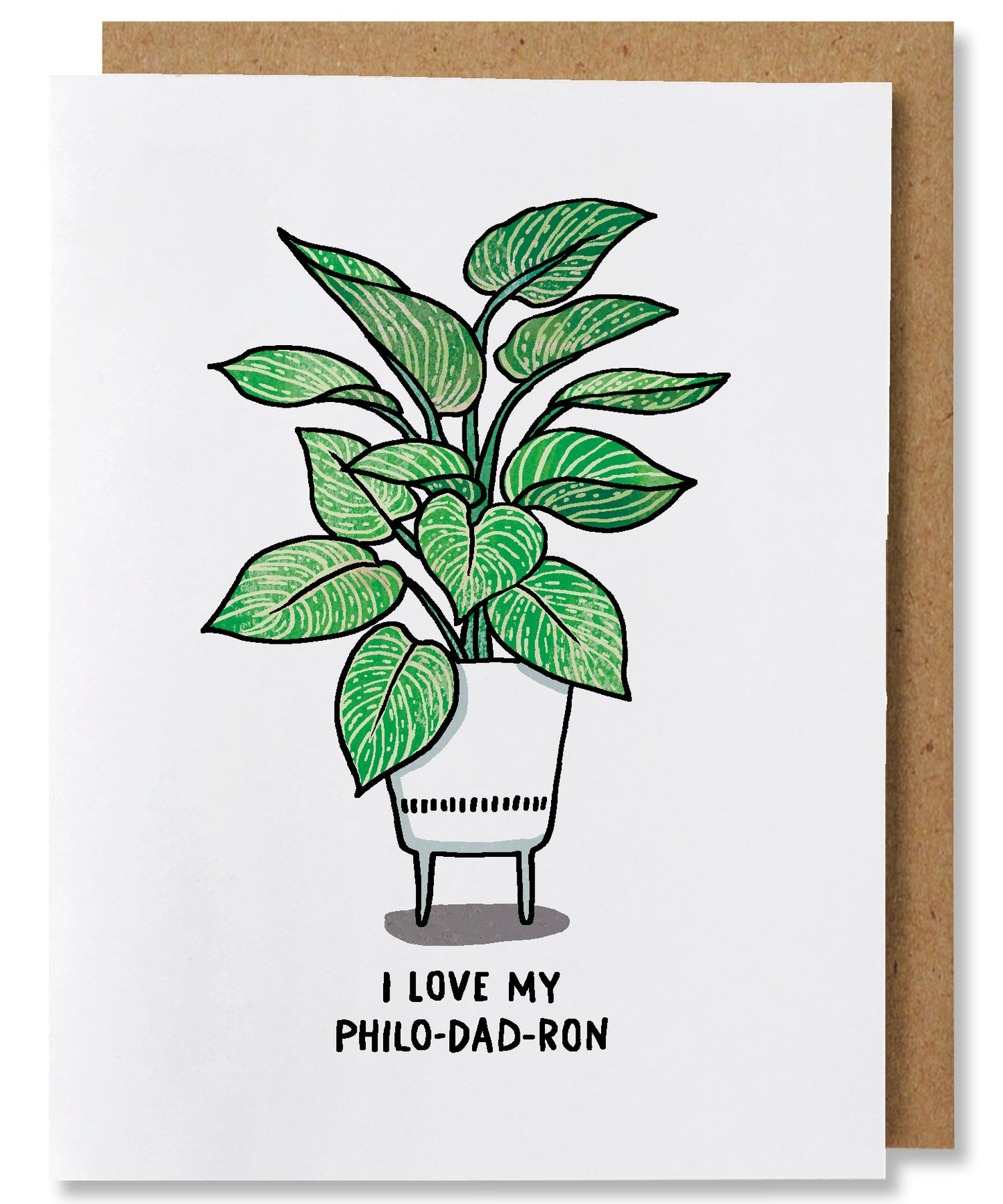 I Love My Philo-dad-ron is a white ground greeting card that features a philodendron birkin plant potted in a white planter with legs. The words beneath say "I love my Philo-Dad-ron". This card is paired with a brown kraft envelope